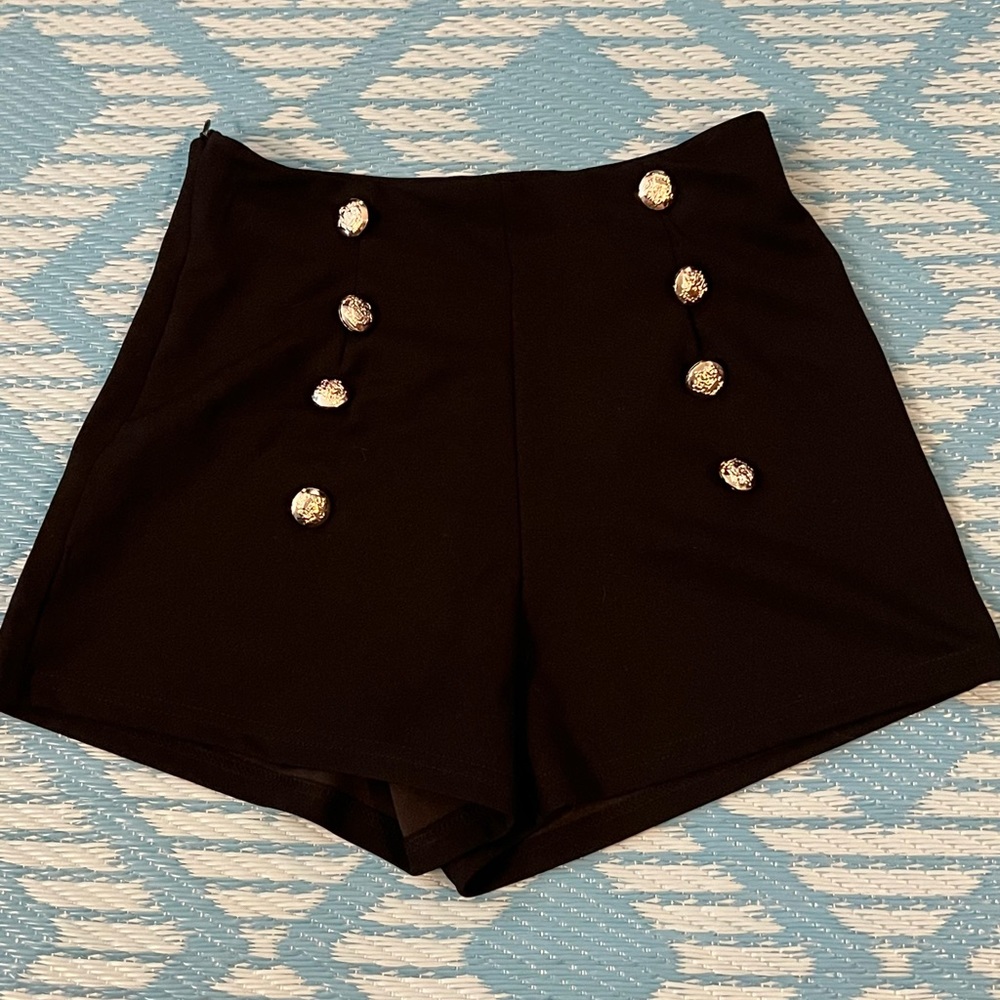 Black shorts with gold buttons